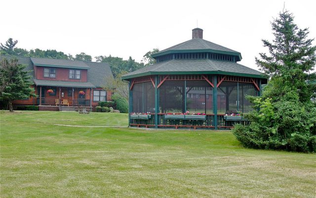 Screened in gazebo with lawn around it